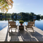 View,Of,Chairs,And,Dock,On,A,Pristine,Lake,With