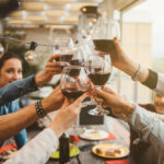 Young,Friends,Celebrating,At,Dinner,At,Sunset,-,Detail,Of